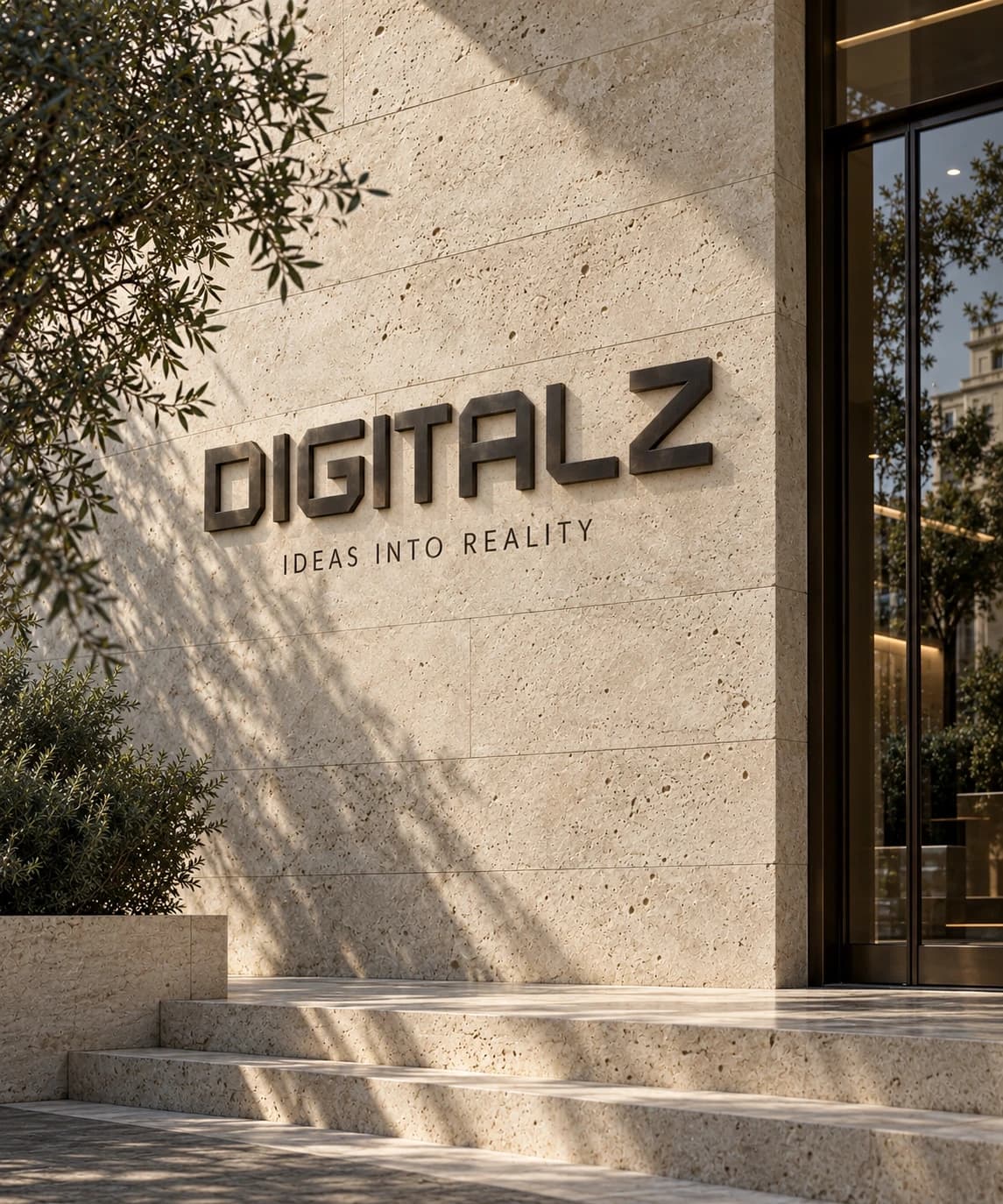 Digitalz's geometric wordmark in bronze on a limestone entrance, with natural olive tree shadows